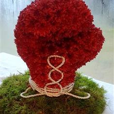 Boxing glove on a mossed base 