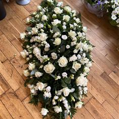 White rose , freesia and eustoma casket spray 