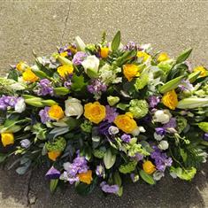 Elegant yellow , lilac and white casket spray 