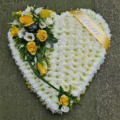 White heart of remembrance with yellow corsage 